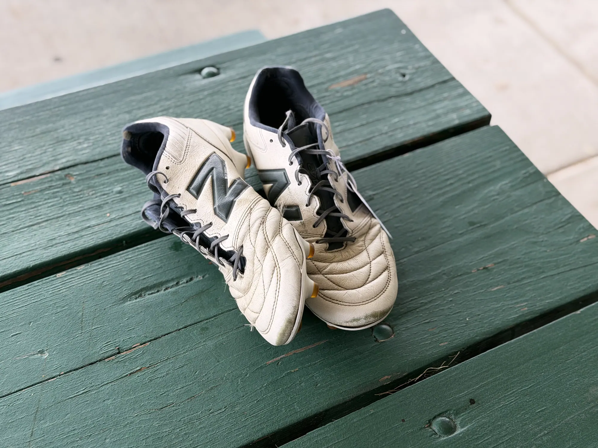 A cleaned white and black pair angled on the table with the laces retied